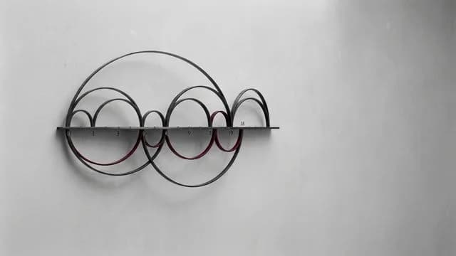 Abstract visualization of interconnected circles and curved lines in grayscale, depicting mathematical patterns and sequences