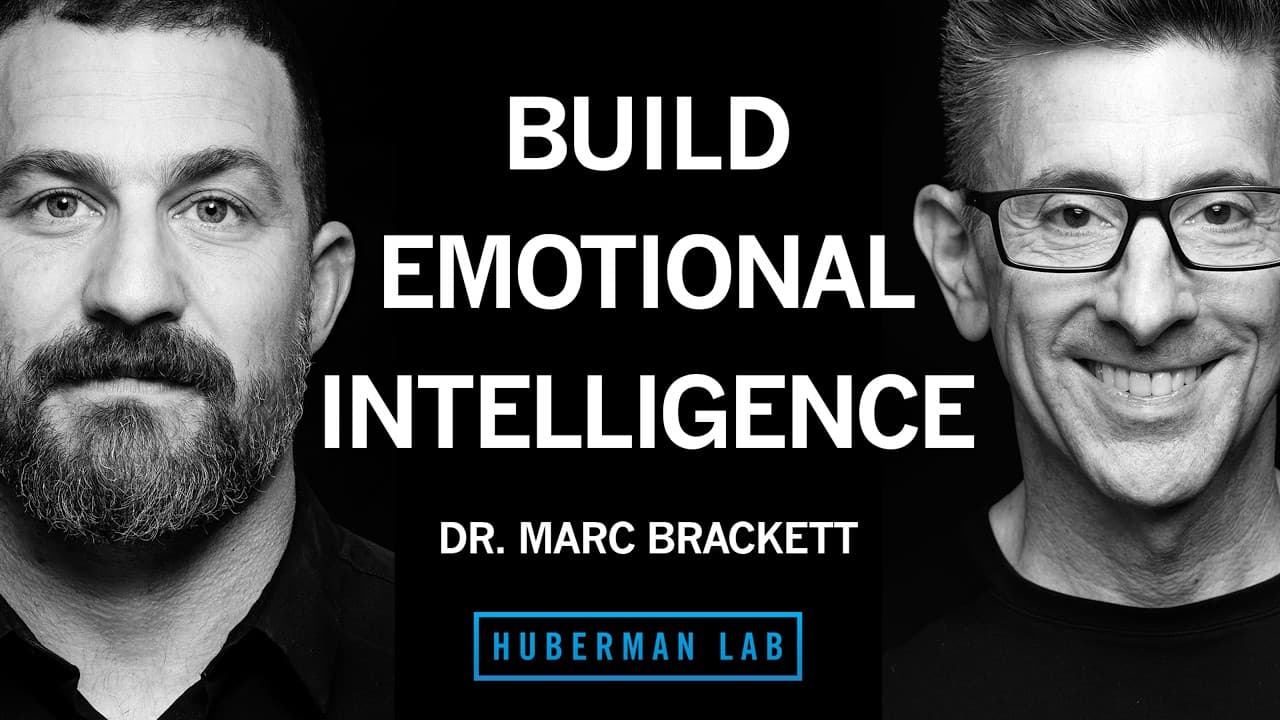 Black and white thumbnail with two men facing camera, white text reading "BUILD EMOTIONAL INTELLIGENCE" and "DR. MARC…