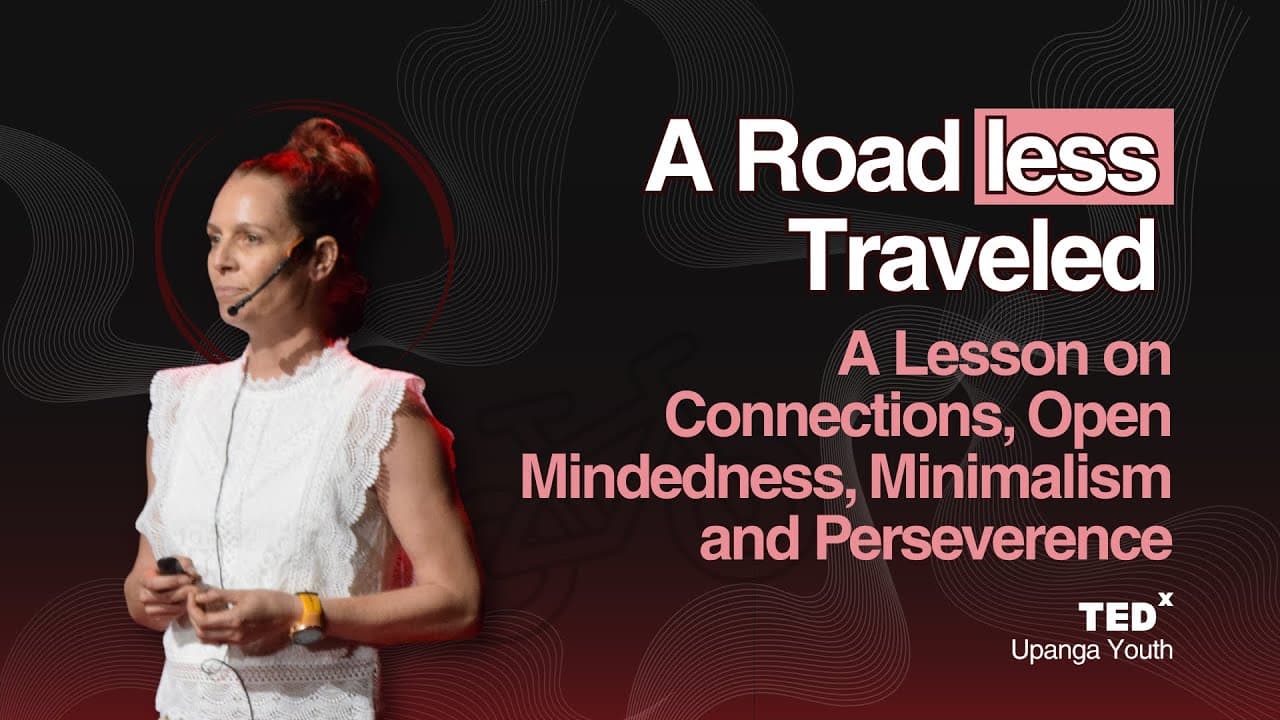 Woman in white sleeveless top speaking on TEDx stage with red lighting and abstract black background design