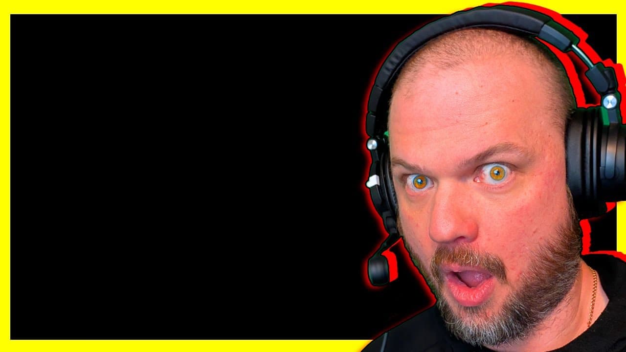 Man wearing red and black gaming headset with shocked expression and wide eyes against black background with yellow border