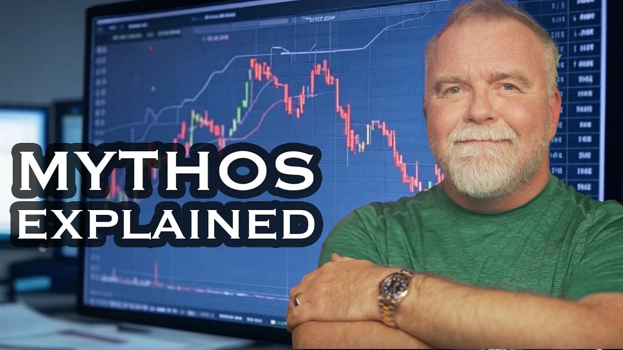 A bearded man in a green shirt sits before a computer monitor displaying a stock market chart with red and green…