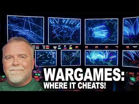 Man with gray beard in green shirt with computer screens displaying blue digital graphics and glowing network patterns…