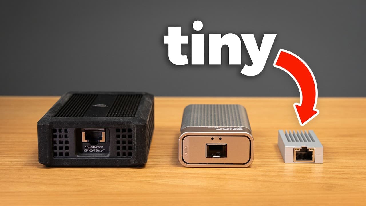 Three network devices decreasing in size from left to right on a wooden surface, with the smallest highlighted by a red…